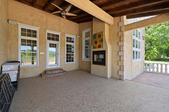 view of exterior entry featuring ceiling fan