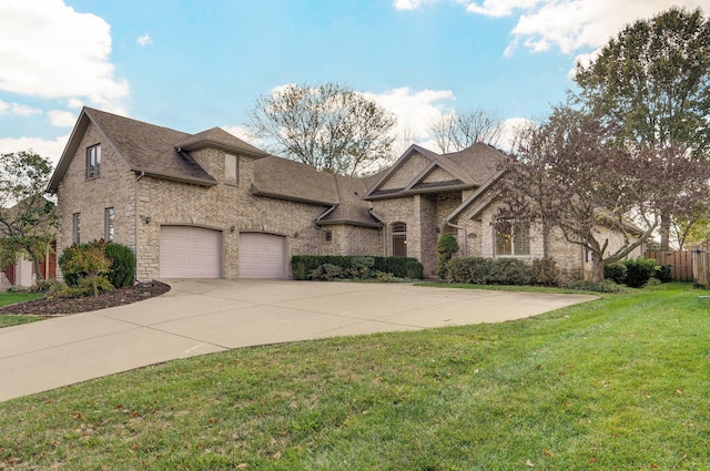 view of front of property with a front lawn and a garage