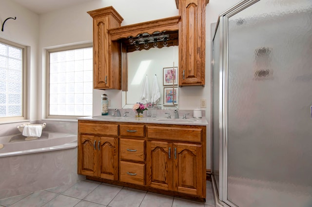 bathroom featuring vanity, tile patterned flooring, and separate shower and tub