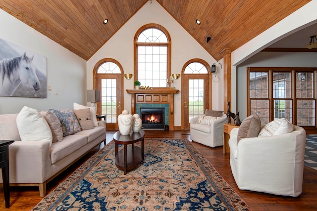 living room featuring high vaulted ceiling, a tiled fireplace, wood ceiling, and dark hardwood / wood-style floors