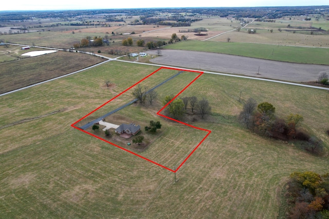 birds eye view of property with a rural view