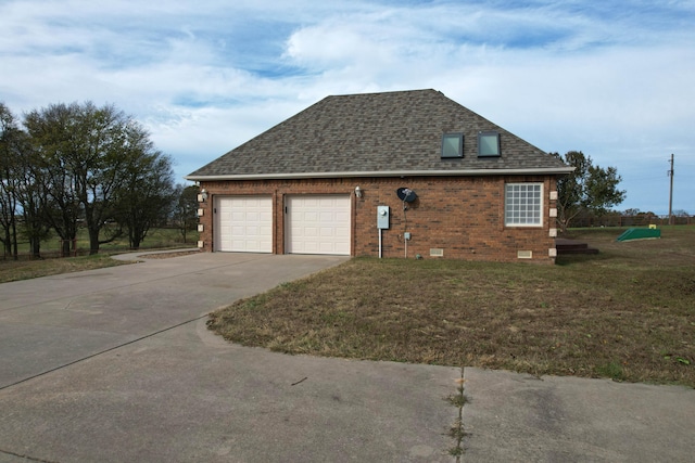 view of home's exterior with a garage and a lawn