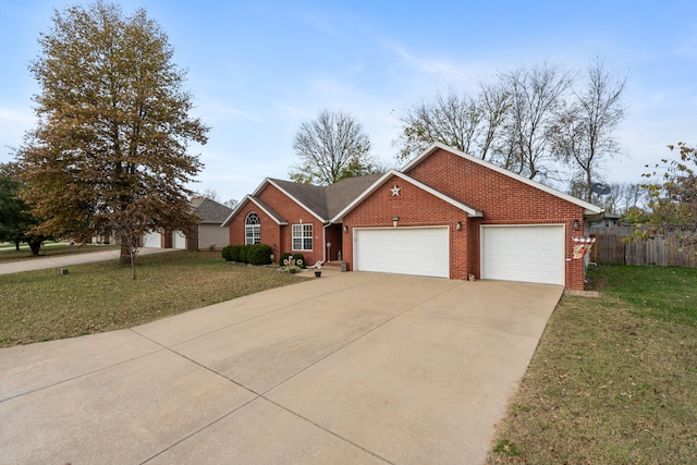 ranch-style home with a garage and a front lawn