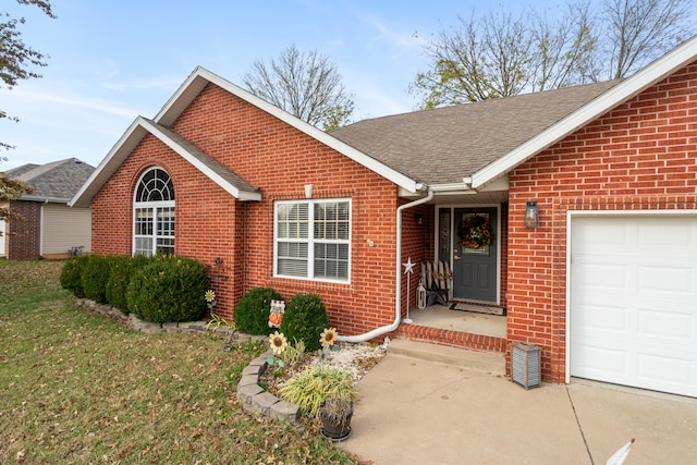 ranch-style home with a garage and a front lawn