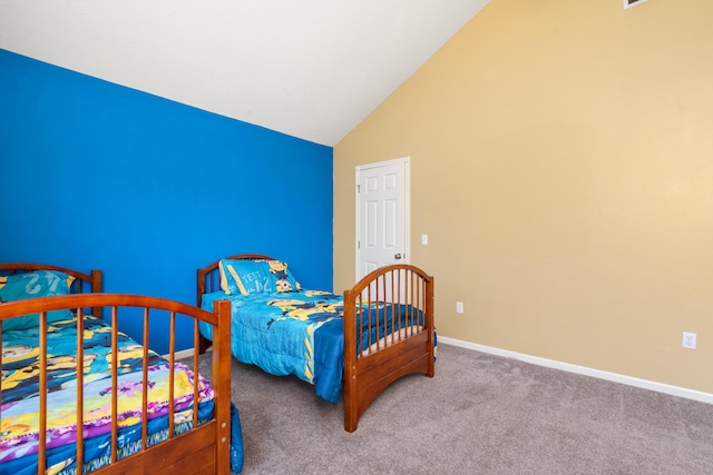 bedroom with high vaulted ceiling and carpet