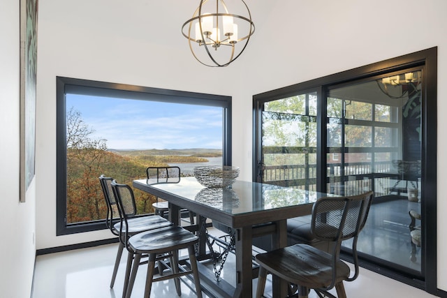 dining area with an inviting chandelier and concrete floors