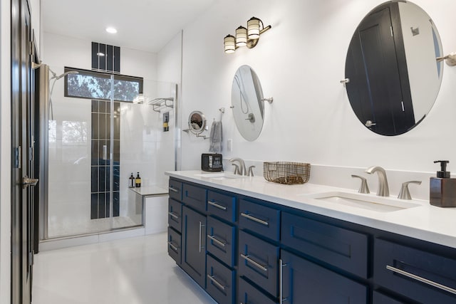 bathroom featuring an enclosed shower and vanity