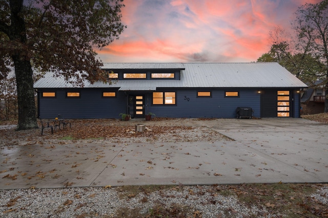 back house at dusk with a garage