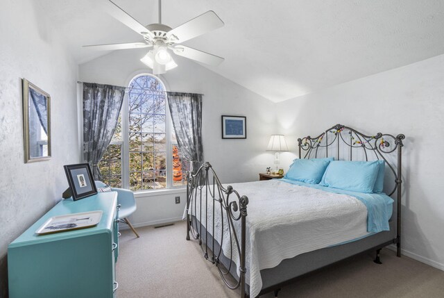 carpeted bedroom featuring lofted ceiling and ceiling fan