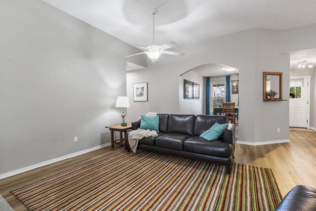 living room with wood-type flooring, ceiling fan, and plenty of natural light