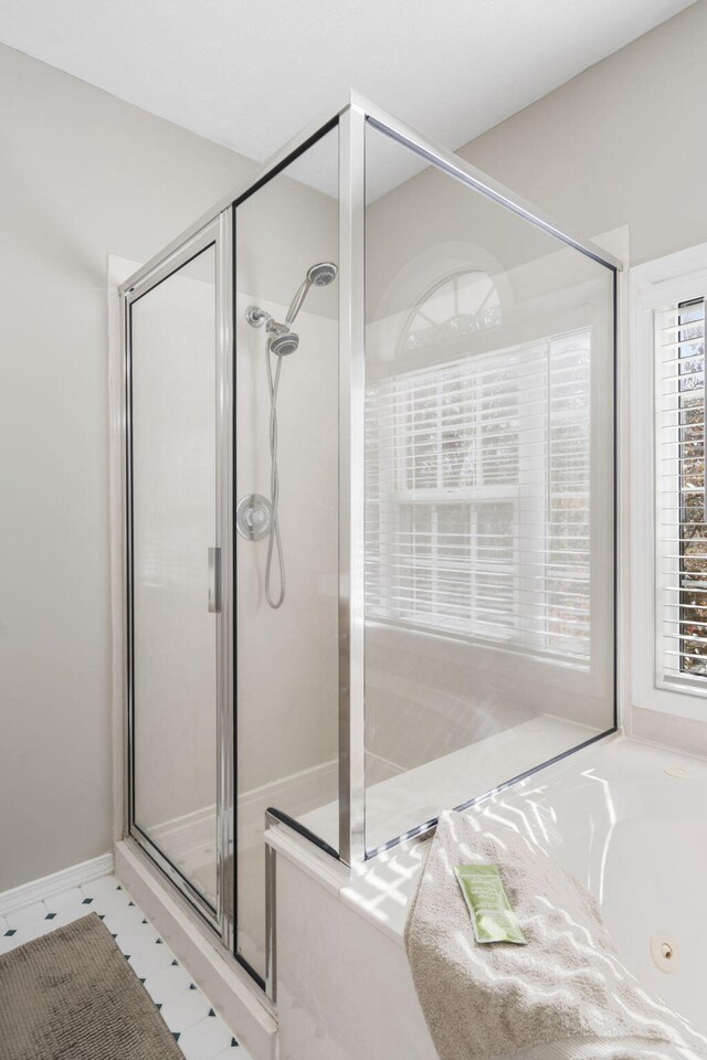 bathroom with shower with separate bathtub and tile patterned floors