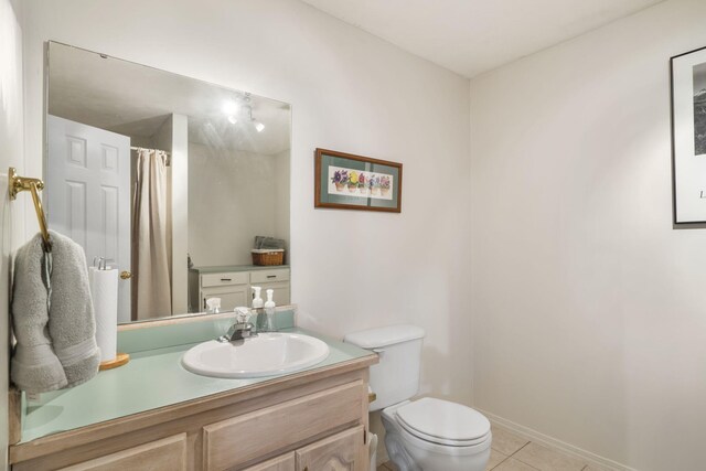 bathroom featuring vanity, walk in shower, tile patterned flooring, and toilet