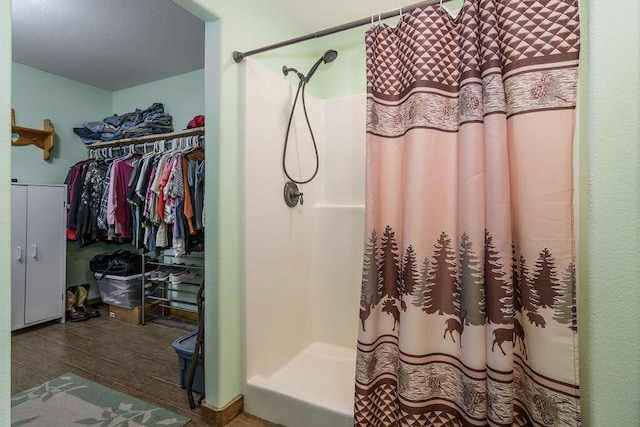 bathroom with hardwood / wood-style flooring and curtained shower