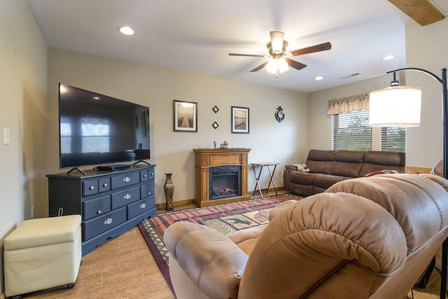 living room featuring ceiling fan and light hardwood / wood-style floors