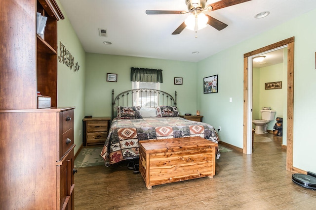 bedroom with wood-type flooring, ceiling fan, and ensuite bath