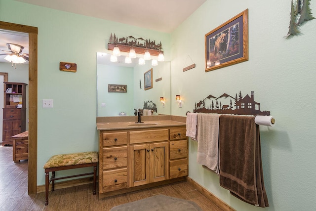 bathroom with wood-type flooring, ceiling fan, and vanity