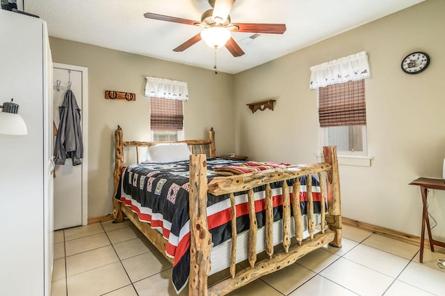 tiled bedroom with ceiling fan