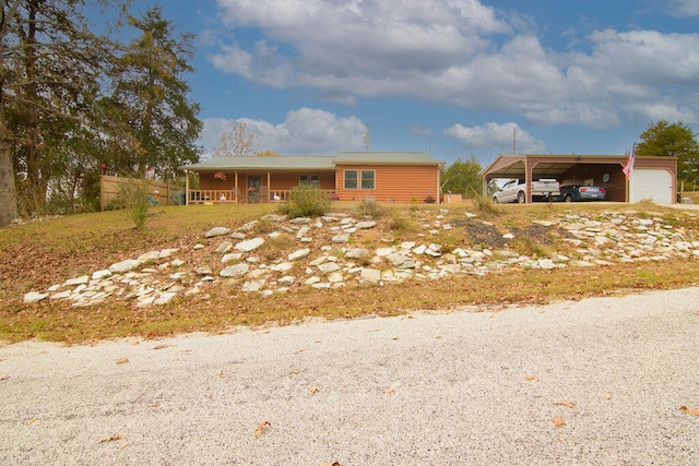 ranch-style house with a garage and a carport