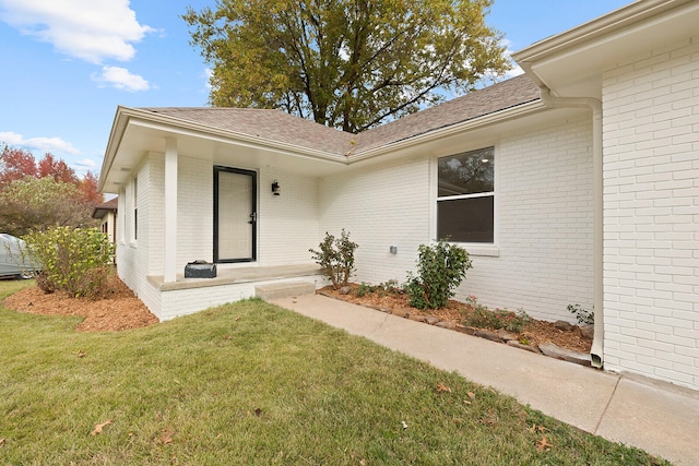 doorway to property with a yard