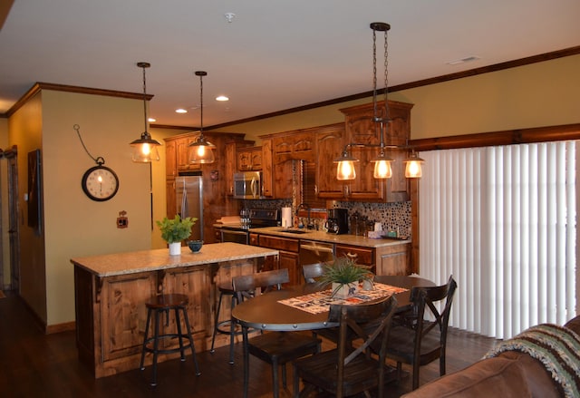 dining room featuring dark hardwood / wood-style flooring, sink, and crown molding