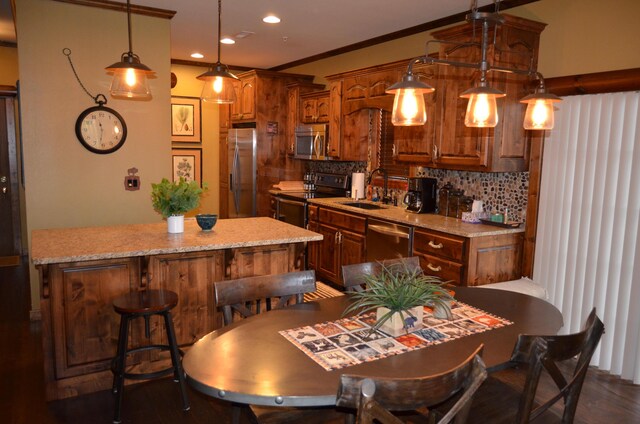 24 Village Trl Unit 1, Branson, MO 65616 - kitchen with stainless steel appliances, a sink, decorative backsplash, a breakfast bar area, and recessed lighting