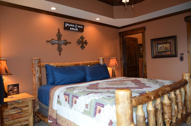 bedroom with a tray ceiling and crown molding