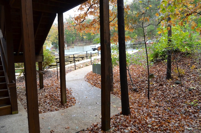 24 Village Trl Unit 1, Branson, MO 65616 - view of patio with a water view and fence