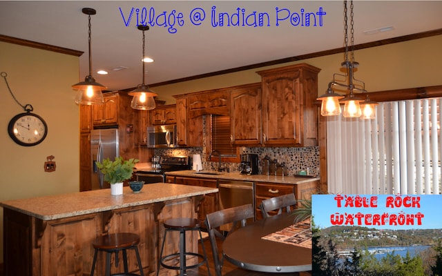 24 Village Trl Unit 1, Branson, MO 65616 - kitchen featuring stainless steel appliances, a center island, tasteful backsplash, ornamental molding, and brown cabinets