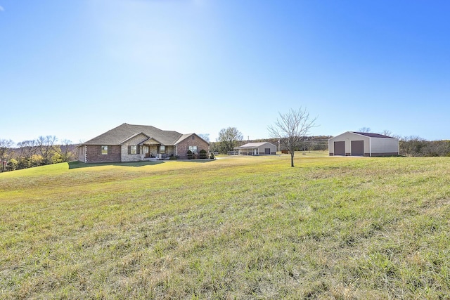 1558 E 432nd Rd, Bolivar, MO 65613 - view of green lawn featuring a detached garage and an outbuilding