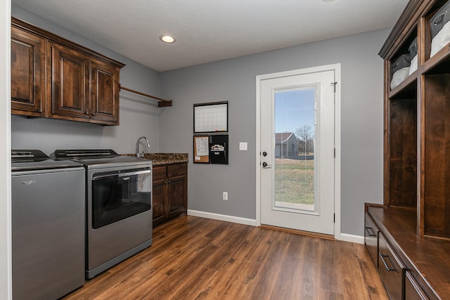 laundry area featuring dark hardwood / wood-style flooring, cabinets, and independent washer and dryer