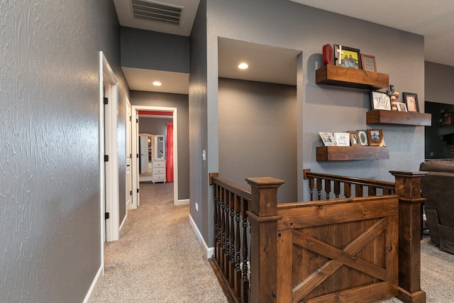 corridor featuring light colored carpet