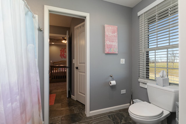 bathroom featuring ceiling fan and toilet