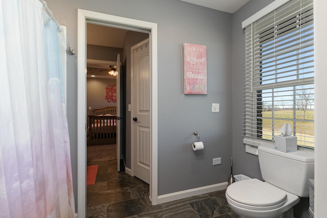 1558 E 432nd Rd, Bolivar, MO 65613 - bathroom with stone finish floors, a ceiling fan, and a shower with shower curtain