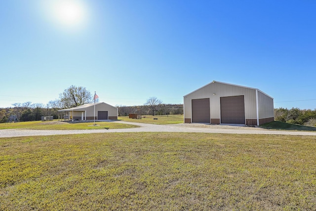 1558 E 432nd Rd, Bolivar, MO 65613 - view of front of home with a garage, a front lawn, and an outdoor structure