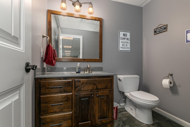 bathroom featuring toilet and vanity