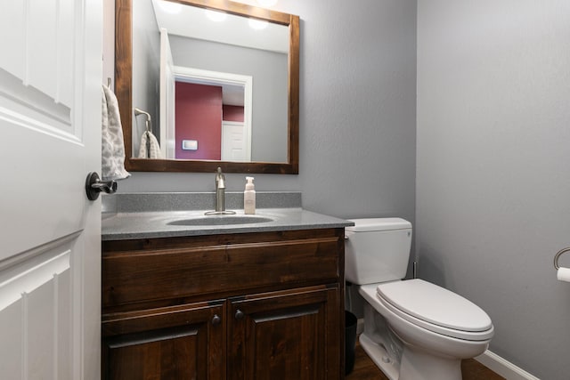 bathroom with toilet and vanity