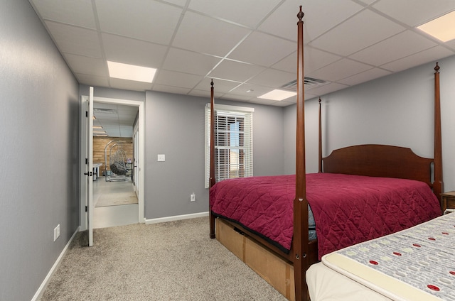 bedroom with a paneled ceiling and carpet flooring