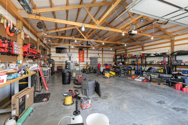 garage featuring a garage door opener and a workshop area