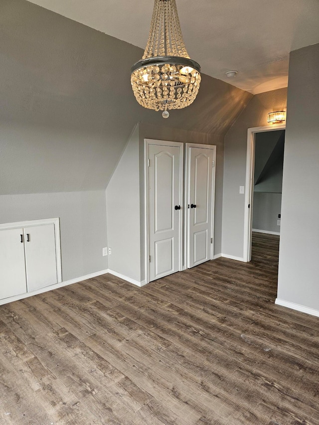 additional living space with dark wood-type flooring and lofted ceiling