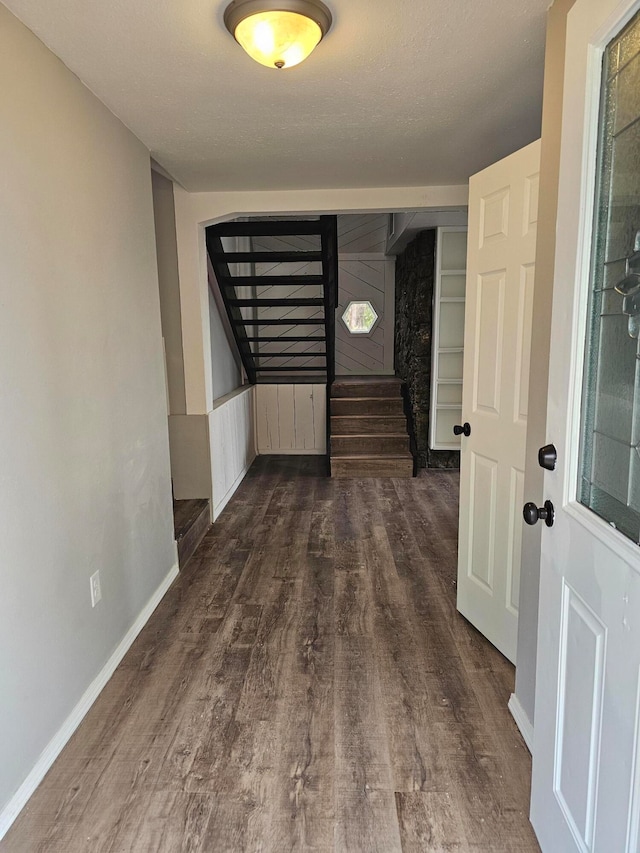 interior space featuring dark wood-type flooring and a textured ceiling