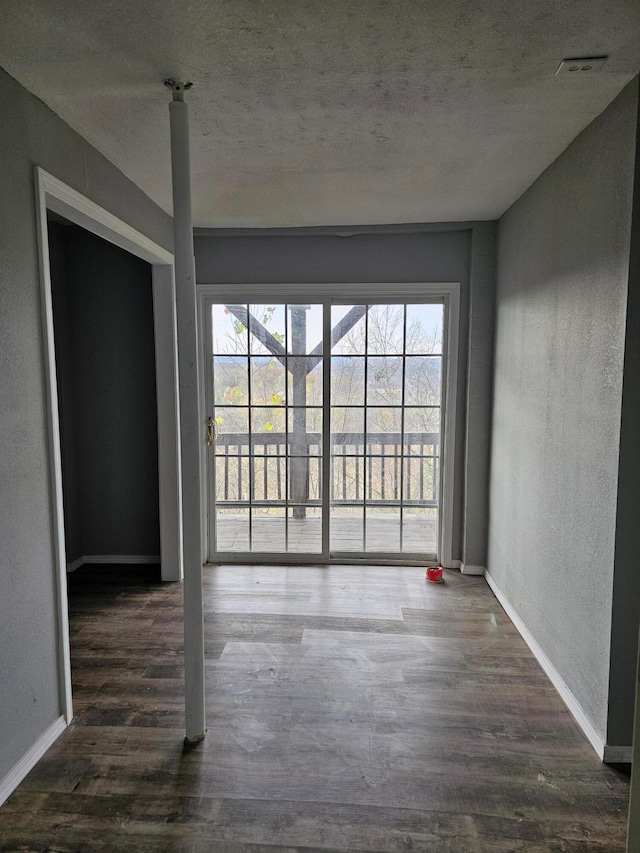 spare room featuring dark hardwood / wood-style flooring