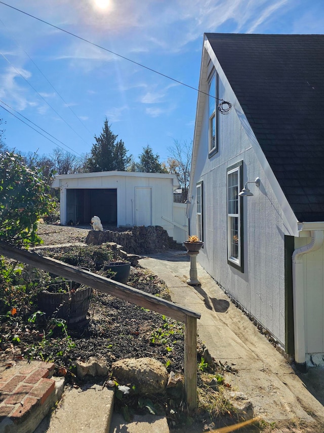 view of property exterior with an outbuilding