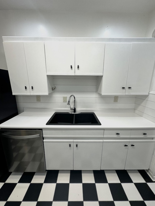 kitchen featuring white cabinets, sink, backsplash, and dishwasher