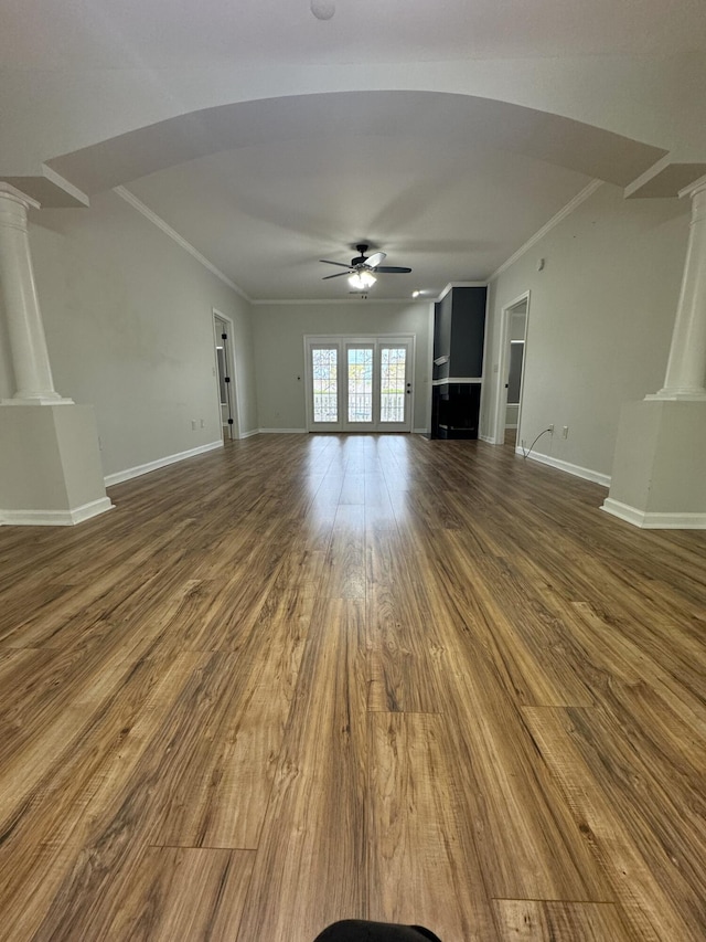 unfurnished living room with ornamental molding, decorative columns, hardwood / wood-style floors, and ceiling fan