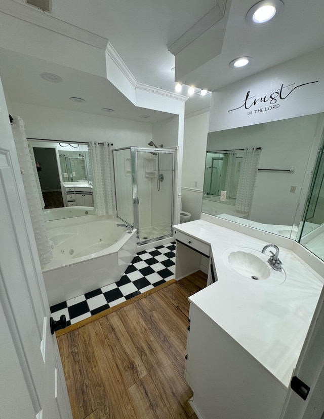 full bathroom featuring hardwood / wood-style flooring, vanity, toilet, and separate shower and tub