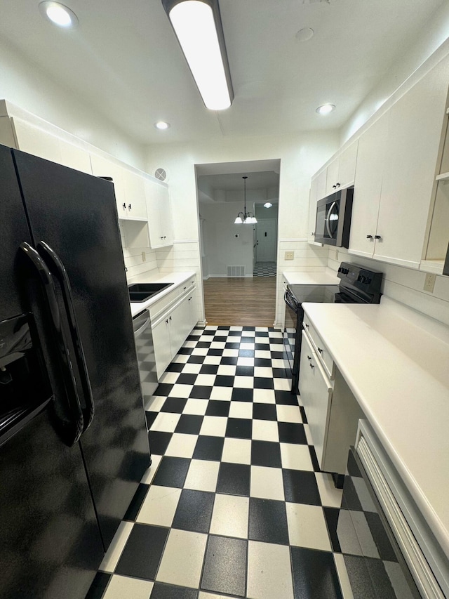 kitchen featuring black appliances, decorative light fixtures, white cabinetry, and decorative backsplash