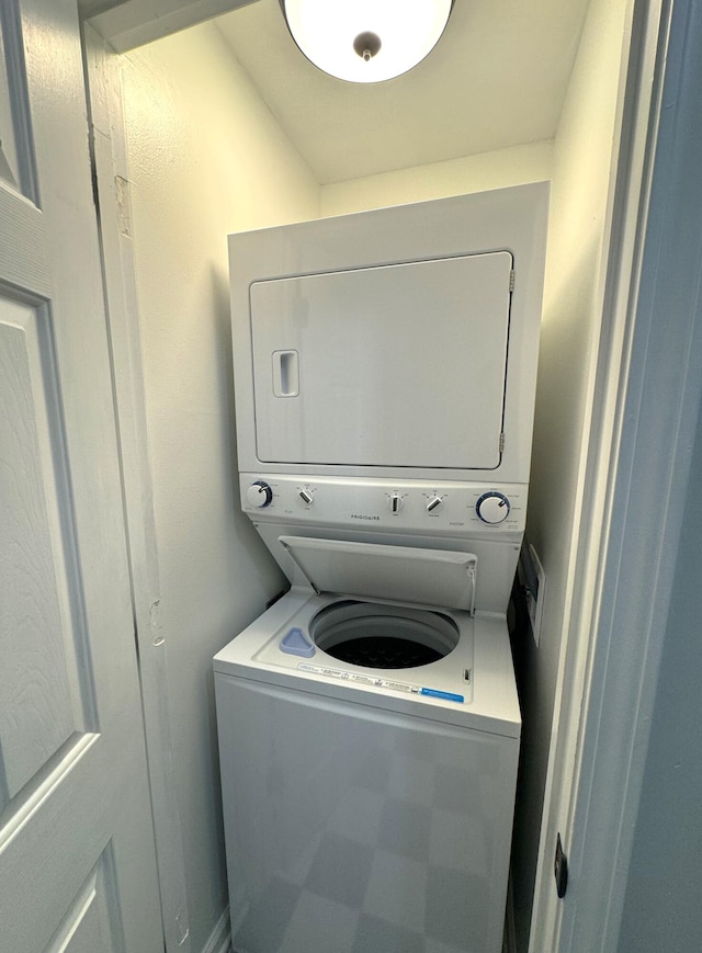 laundry room with stacked washer and dryer