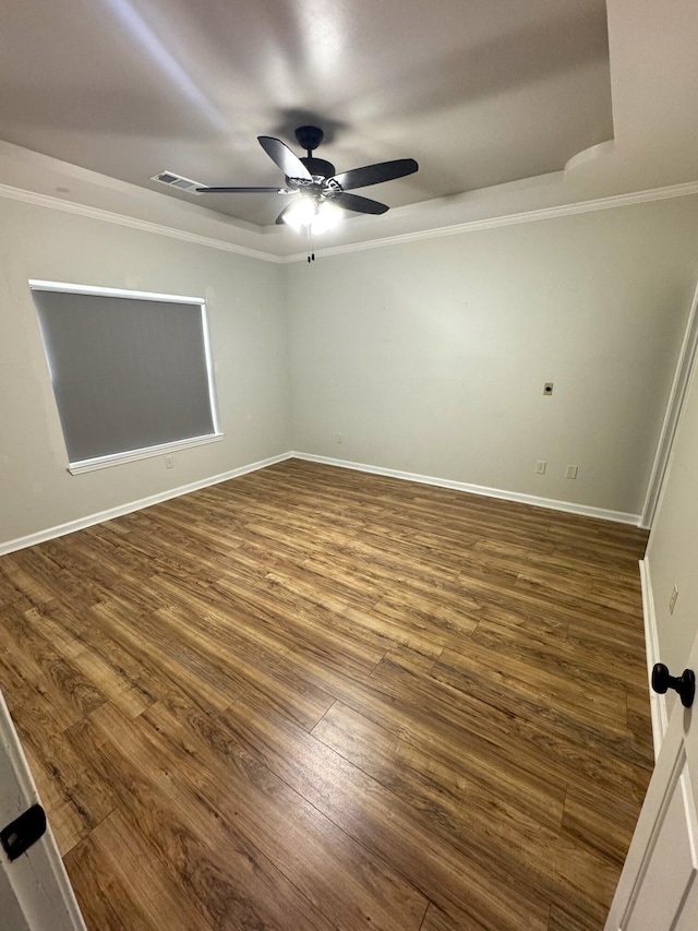 unfurnished room featuring dark wood-type flooring, ceiling fan, and ornamental molding