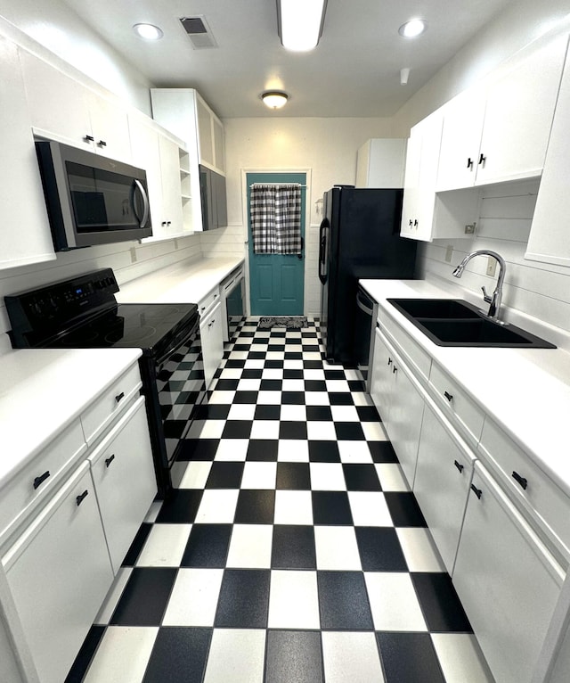 kitchen with decorative backsplash, white cabinetry, sink, and stainless steel appliances