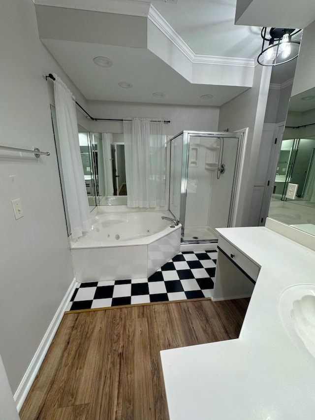 bathroom featuring independent shower and bath, vanity, wood-type flooring, and crown molding